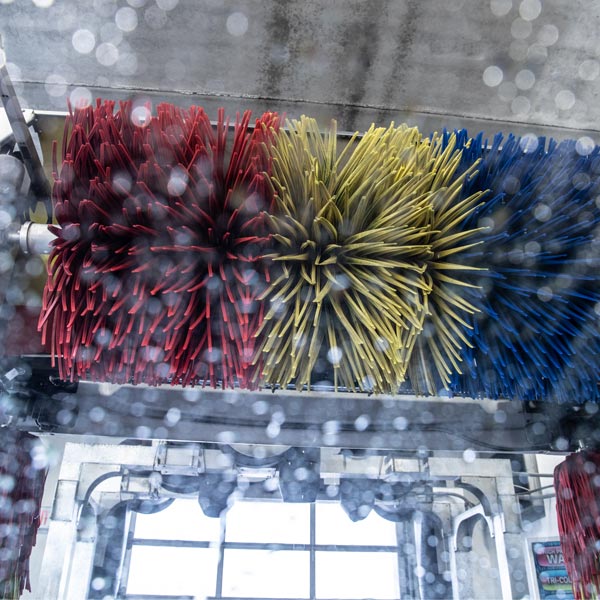 red yellow and blue automatic carwash brushes