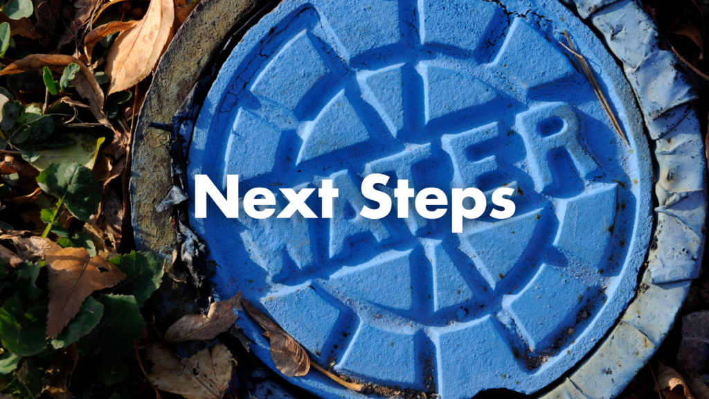 next steps written over a sewer cap