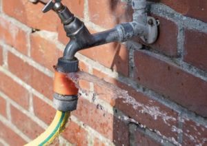 water leaking from a garden hose attachment